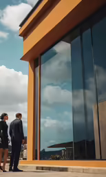 a couple of people are standing outside a building