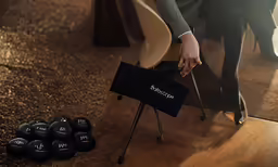 a suit holding onto a bag while standing in front of a mirror