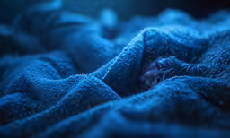 a woman is wrapped up in a blanket