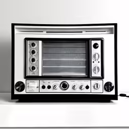 an old fashioned toaster oven with electronic components sitting on top of it