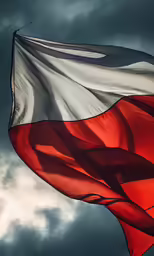 a red white and black flag flying high