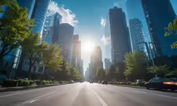 cars moving down a city street on a sunny day