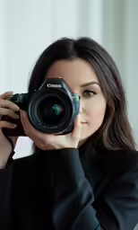 a woman with a black shirt holding a camera