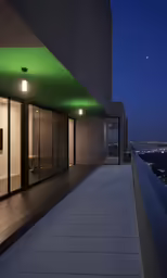 the front of a building at night with the lights on