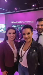 three people in a photo taken at an event