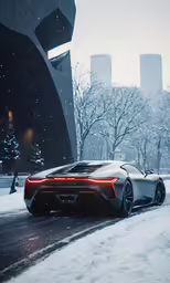 the car is driving on the road in the snow