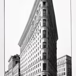 tall buildings in front of a very big building