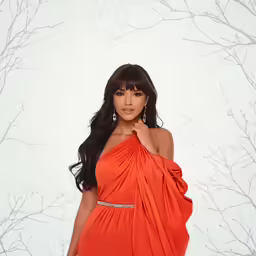 a young woman posing for the camera in an orange dress