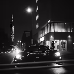people are riding in the back of their cars on a city street at night