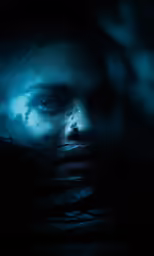 the face of a woman that appears to be floating under water