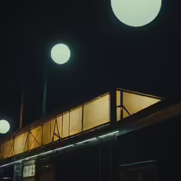 two street lights shine brightly above a building