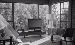 the living room features an entertainment center and large windows that let in plenty of natural light
