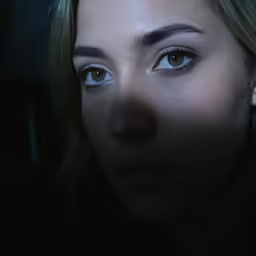 a young girl with blue eyes looks into the camera
