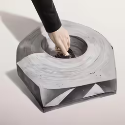 a hand touching the top of a table cover