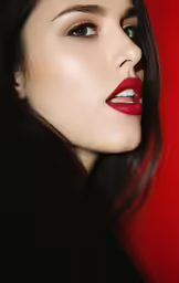 a beautiful woman with dark hair and bright lipstick