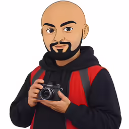 an adult with a beard holding a camera