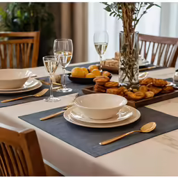 the table has a lot of plates and silverware on it