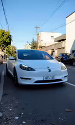 a white car that is parked on the side of a street