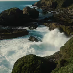 waves breaking up on rocks near the sea shore