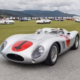 the silver car with red stripes is driving down the road