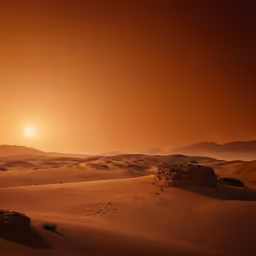 the sun sets over the desert terrain on the horizon