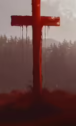 a cross sits in the fogy forest at night