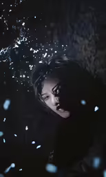 an asian woman stands in the rain, and looks at the camera