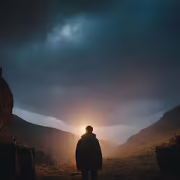 a man stands on a field at night