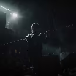 the violin player has long rope, and is aiming