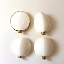 three white knobs mounted on the wall