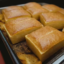 a group of breads sitting on top of a metal pan