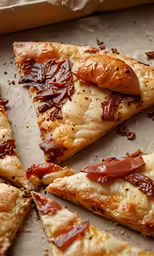 a couple pieces of pizza on a metal tray