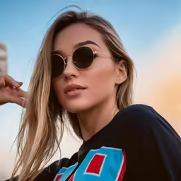 an image of a woman in sunglasses that is wearing the same thing