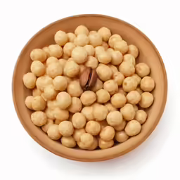chickpeas in a bowl with a walnut kernel