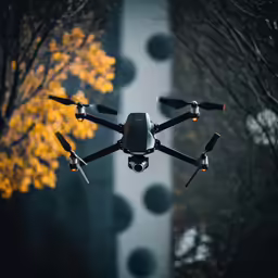 a black remote control plane flying through the air