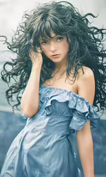 a woman standing with her hair blowing in the wind