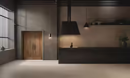 a kitchen that has two lamps on each side of the counter