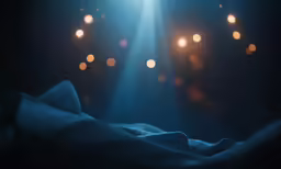 a very dimly lit room has a light streaming from the ceiling