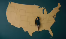 a woman standing on top of a map