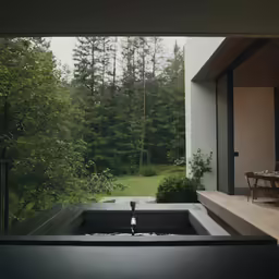 view out from inside a large window, looking outside at trees