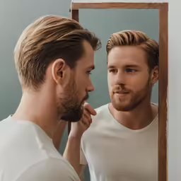 man looking in mirror with reflection of himself