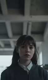 a woman standing next to a ceiling with a lot of beams