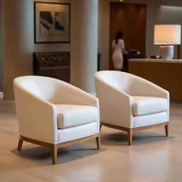two white chairs with wood arms in a room