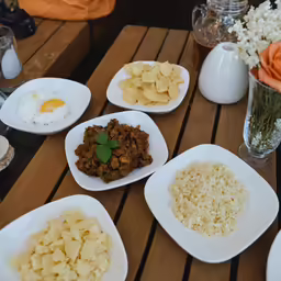 several plates and bowls of food are shown