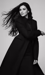 a woman with long hair in black clothes