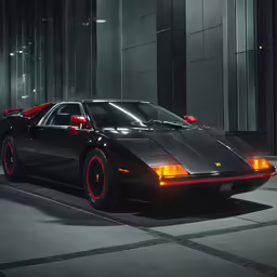 a black sports car with red rims parked on a paved surface