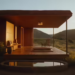 an empty lounge sitting under the shade of a roof with a pool