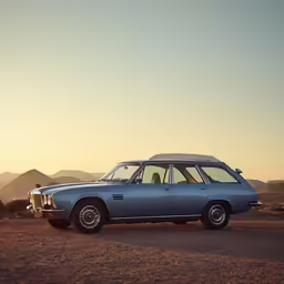 a classic blue station wagon in the desert