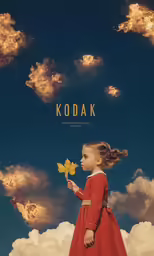 a little girl in a red dress holding a flower
