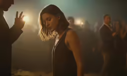 a woman standing in front of another man